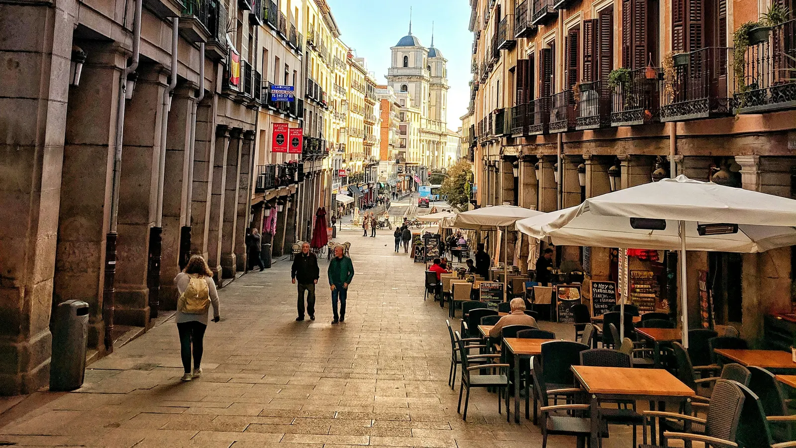 Walkable street in Madrid with outdoor terraces and people strolling